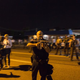 St. Ann, Mo., police Lt. Ray Albers points an assault rifle at a protester Aug. 19, 2014, in Ferguson, Mo. Albers, who was forced to lower his weapon and was escorted from the area by a police sergeant, according to a statement released by the St. Louis County Police Department, was relieved of duty and suspended indefinitely Aug. 20.
Aaron P. Bernstein/Getty Images